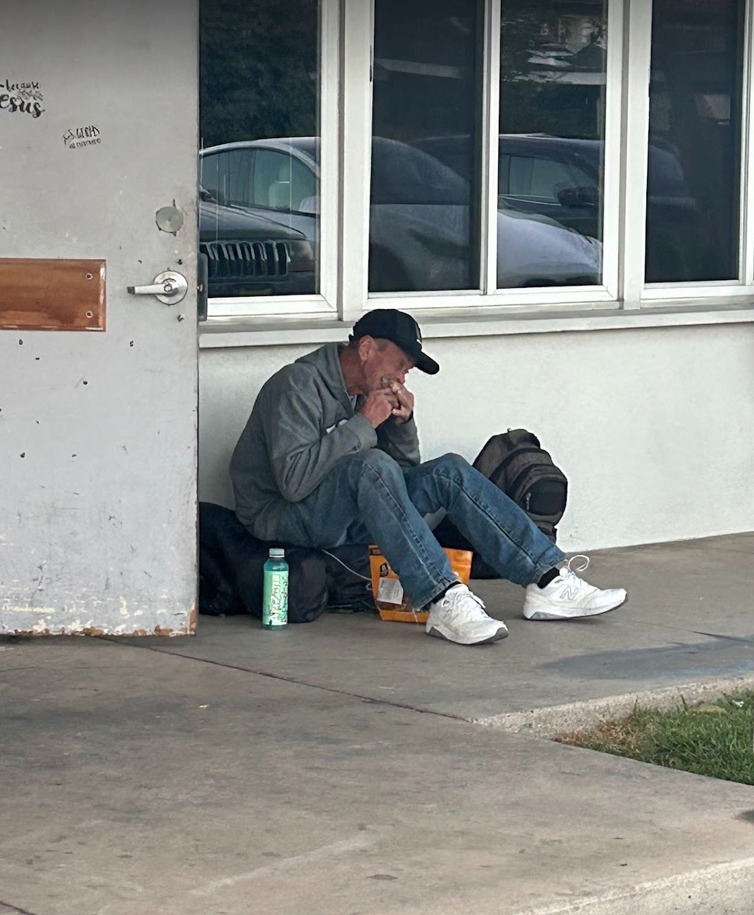 homeless man eating food at the church kitchen